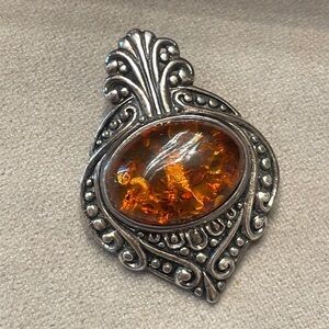 Vintage Amber, and sterling silver pendant by Stauer.